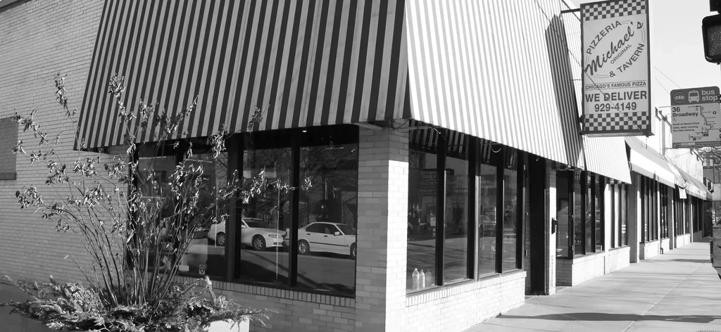 Exterior of Michael's Original Pizzeria & Tavern with awnings and windows.