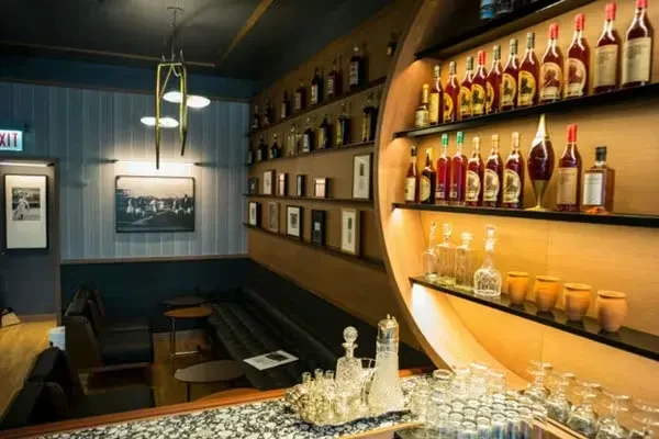 Interior view of a stylish restaurant bar and seating area.
