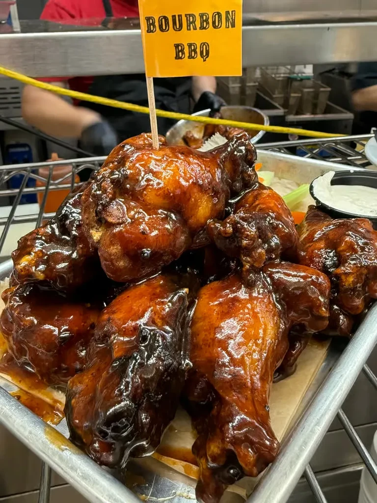 Bourbon BBQ chicken wings with sauce, celery, and dressing.