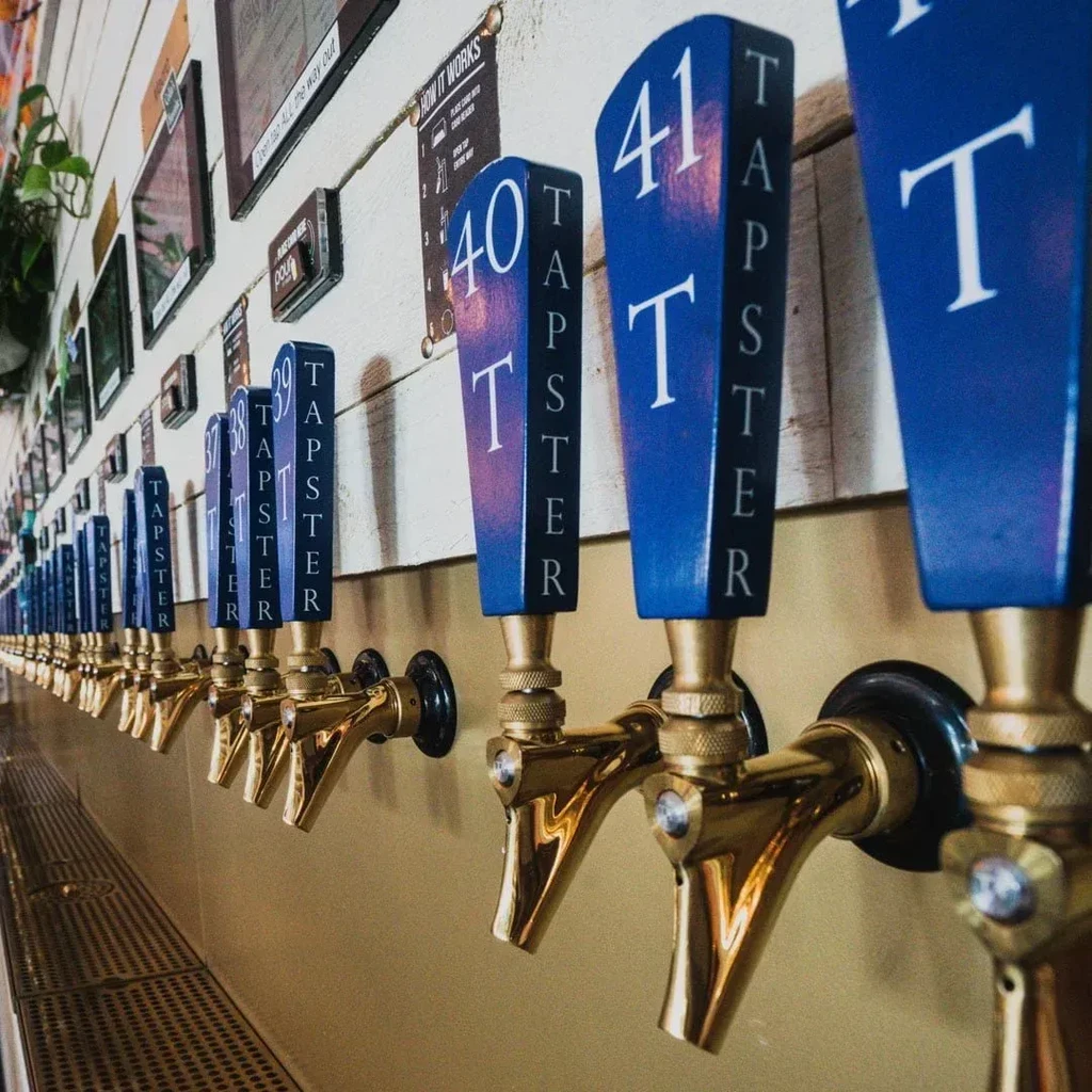 Numbered beer taps with blue and black tap markers.