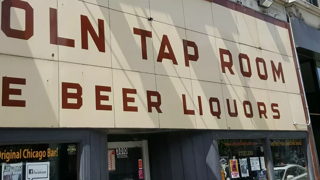 Exterior facade of Lincoln Tap Room displaying its name and offerings.
