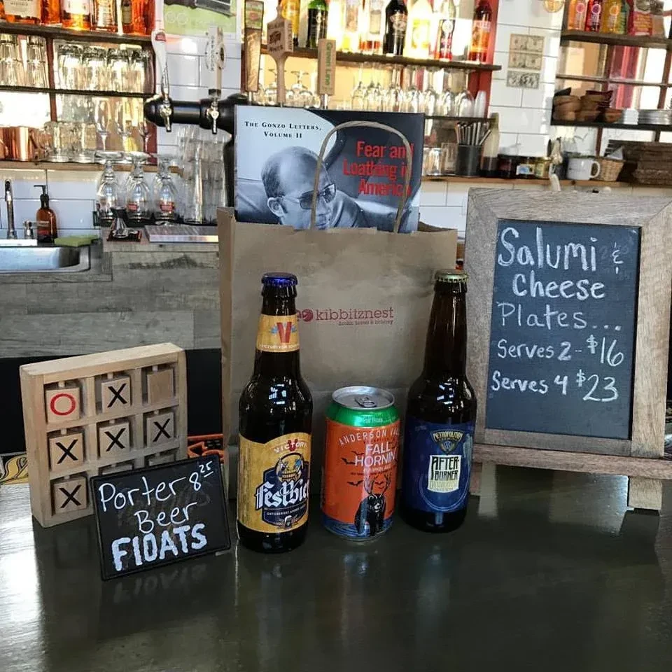 Bar counter with beer, snacks, and "Fear and Loathing in America" book.