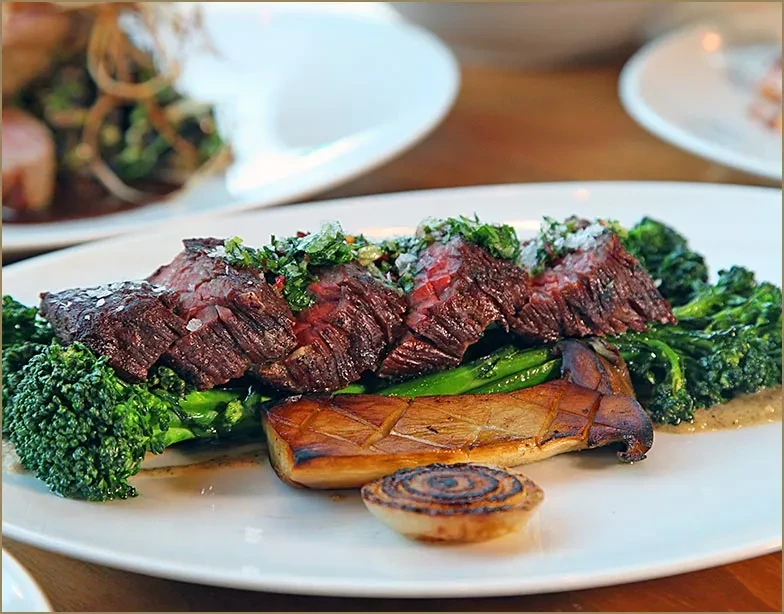 Medium-rare steak, broccolini, grilled portobello mushroom with onion.