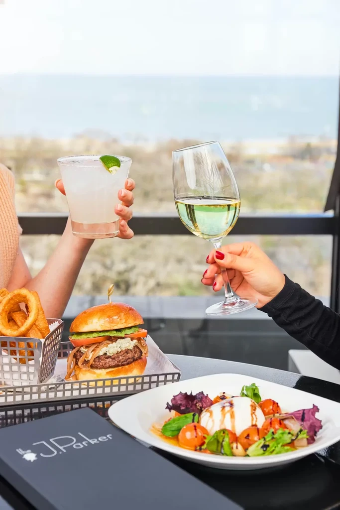 Food and drinks at a restaurant with a scenic water view.