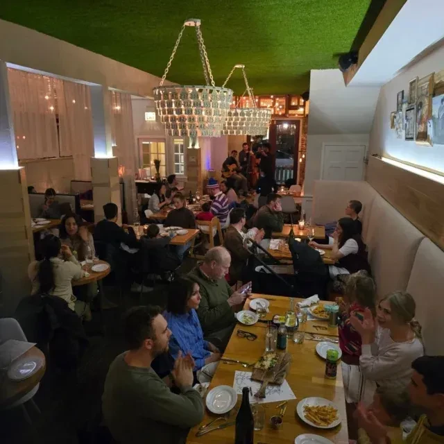 Restaurant interior with patrons, distinctive decor, and live music.