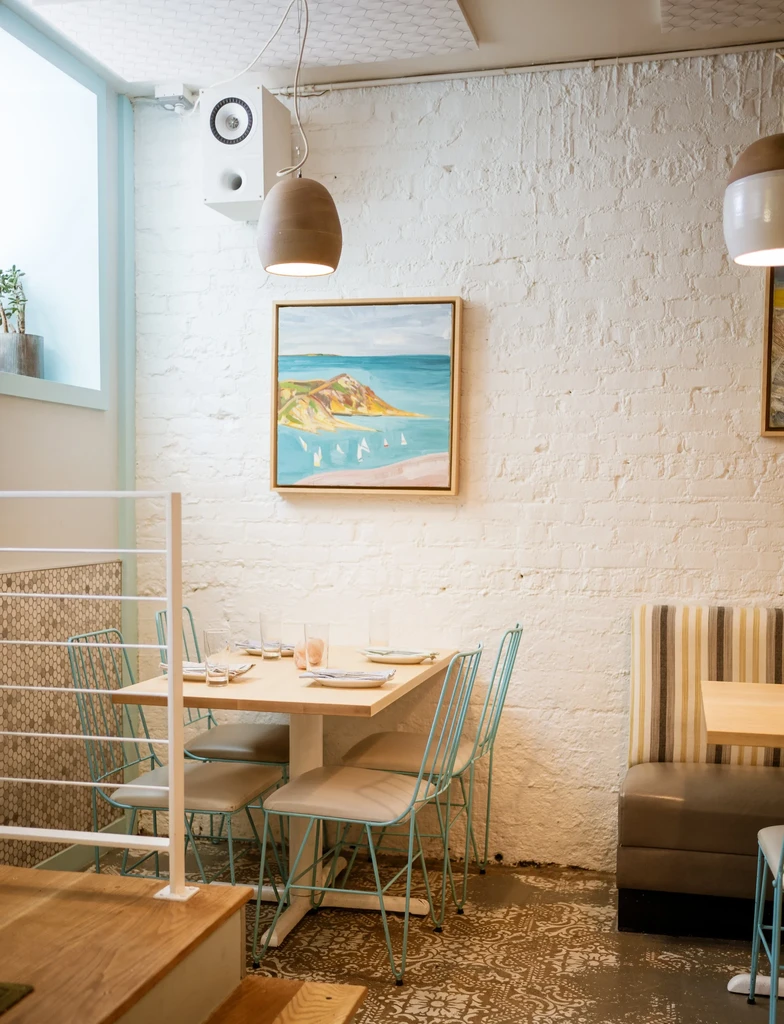 Restaurant interior with tables, chairs, and booth seating.