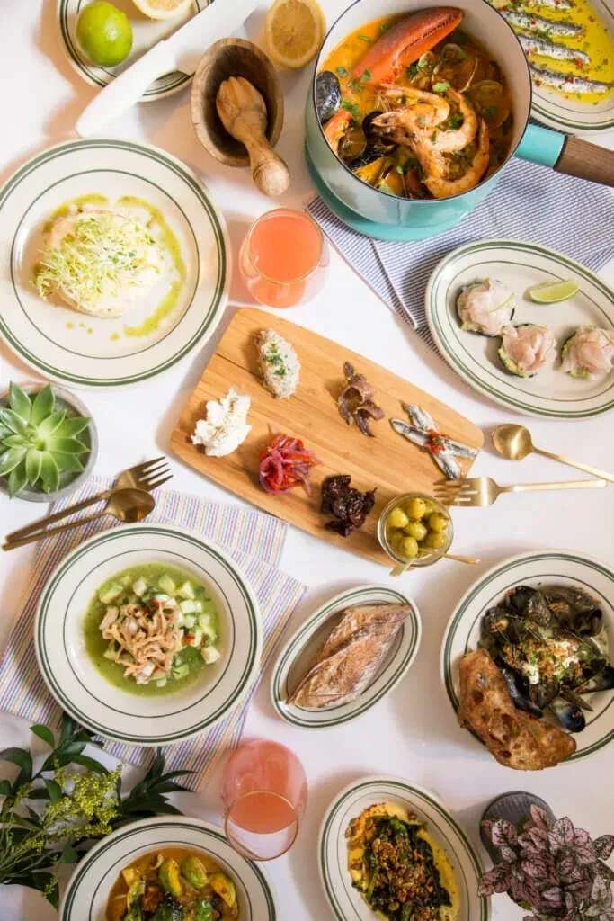 Overhead shot of a table with a variety of seafood dishes.