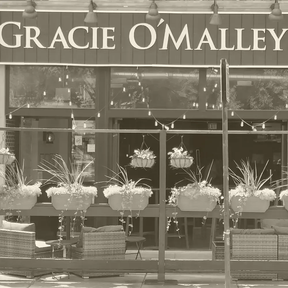 Sepia photo of Gracie O'Malley restaurant exterior with outdoor seating.