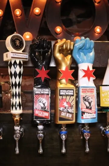 Four beer tap handles, one "3 Philosophers," three "Revolution Brewing."