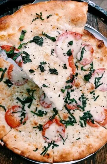Close-up overhead shot of freshly baked pizza with stretchy cheese.