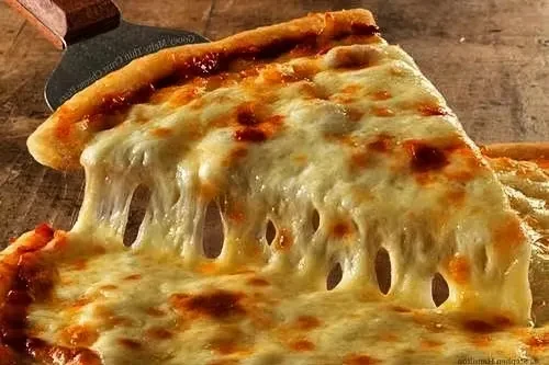Slice of hot pizza with molten cheese stretching.