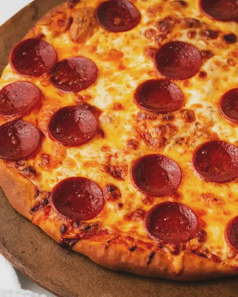 Overhead shot of a freshly baked pepperoni pizza.
