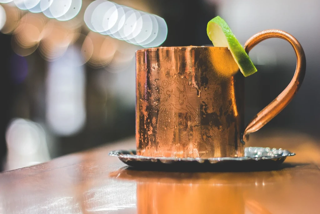 Moscow Mule cocktail in a copper mug with lime.