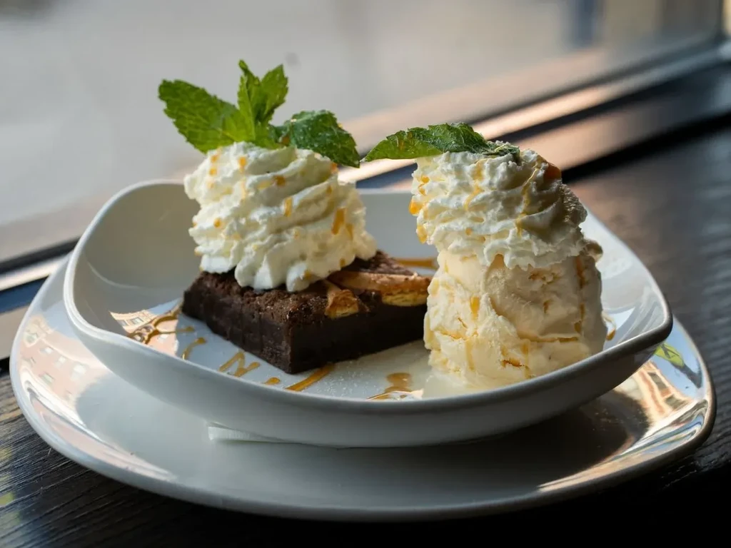 Brownie and vanilla ice cream with whipped cream and caramel sauce.