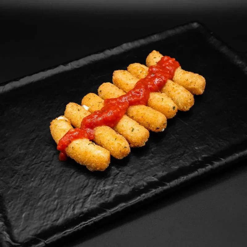 Fried mozzarella sticks with red sauce on a dark platter.