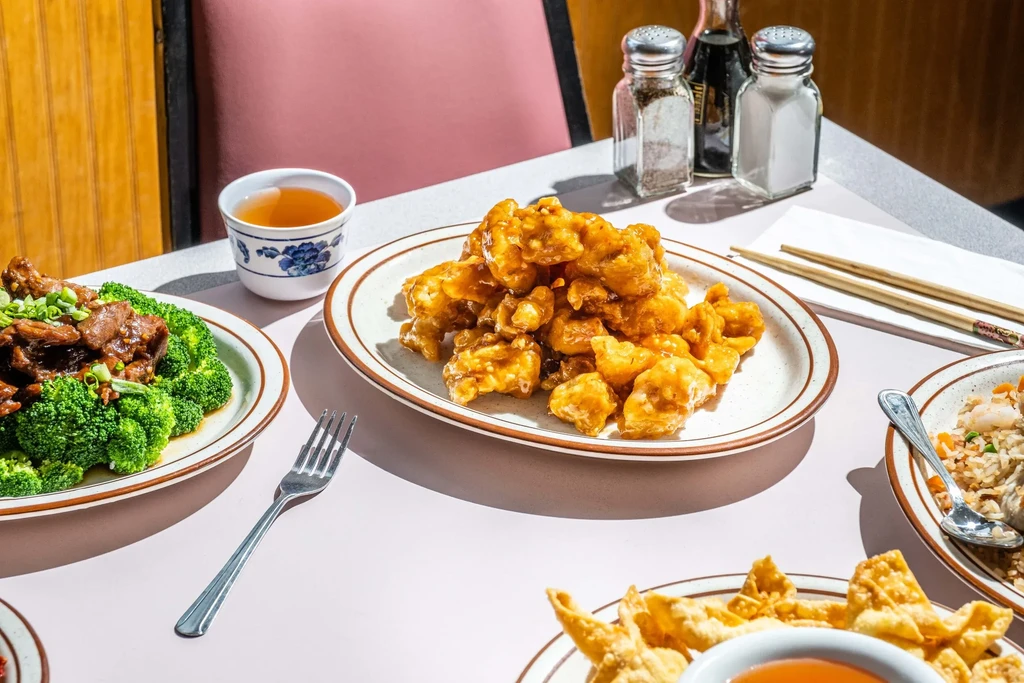 Assortment of Chinese American dishes on a restaurant table.