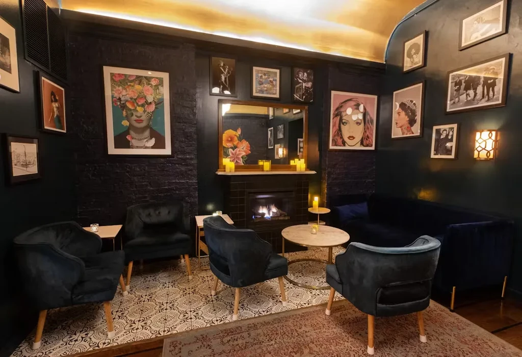 Velvet chairs, marble tables, and art in a cozy lounge.