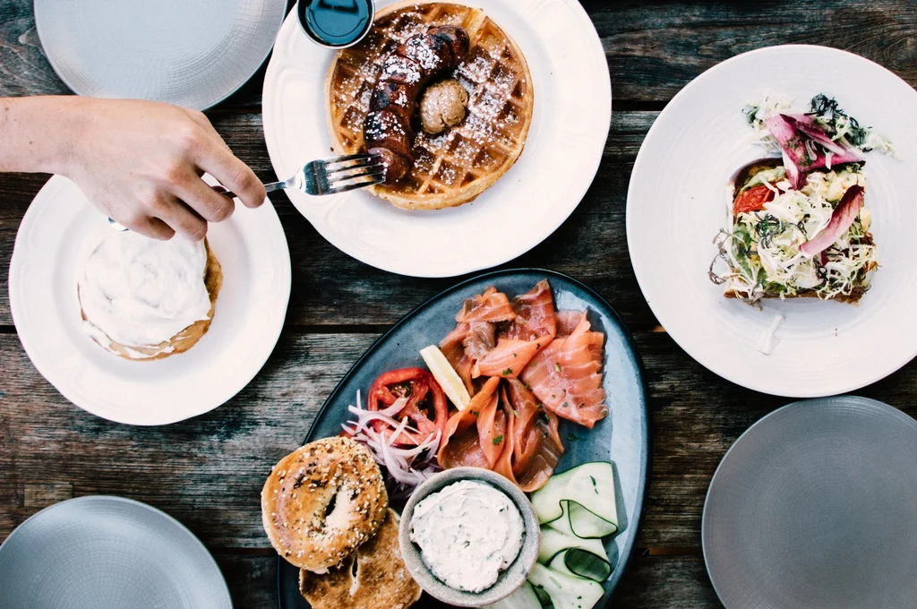 Top-down view of a rustic table with a breakfast and brunch spread.