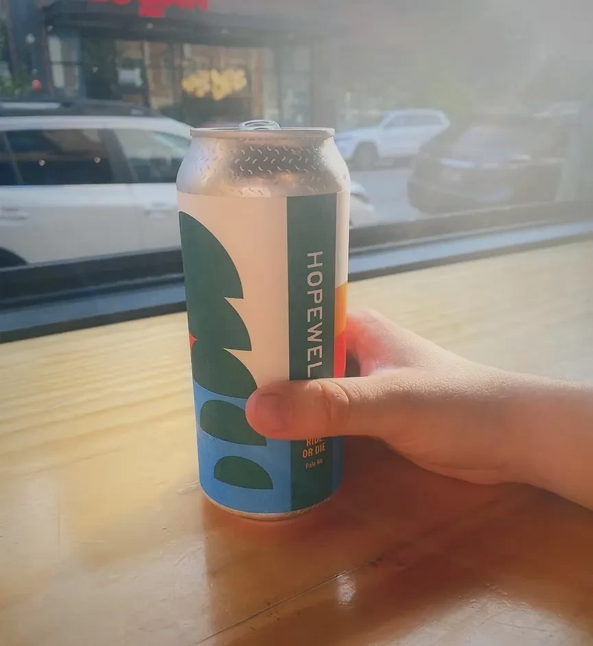 Hand holding a cold silver can of HOPEWELL Pale Ale.