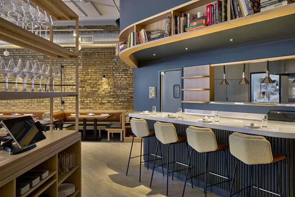 Interior view of a modern restaurant and bar with a marble counter.