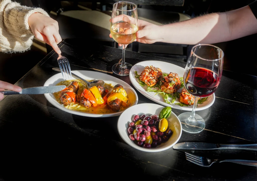 Close-up of a dining table with multiple dishes and drinks.