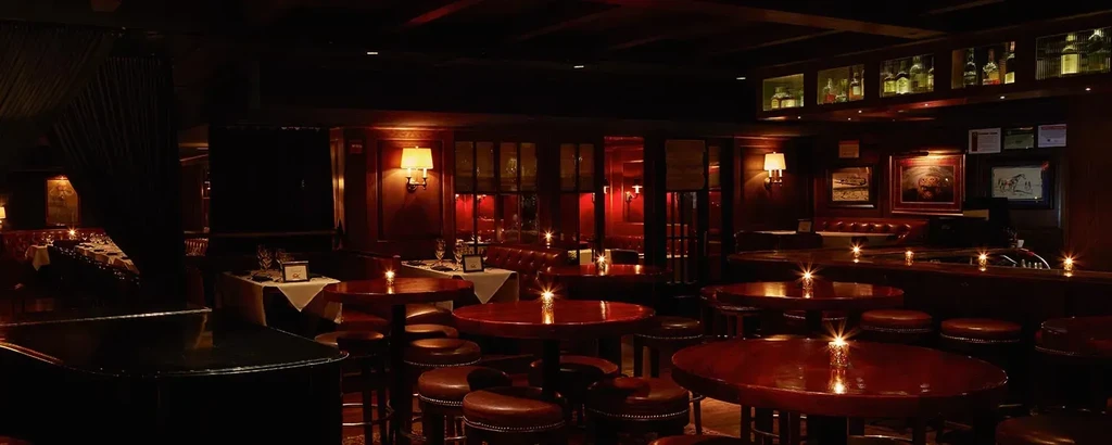 Interior of an upscale bar or restaurant, dimly lit with warm ambiance.