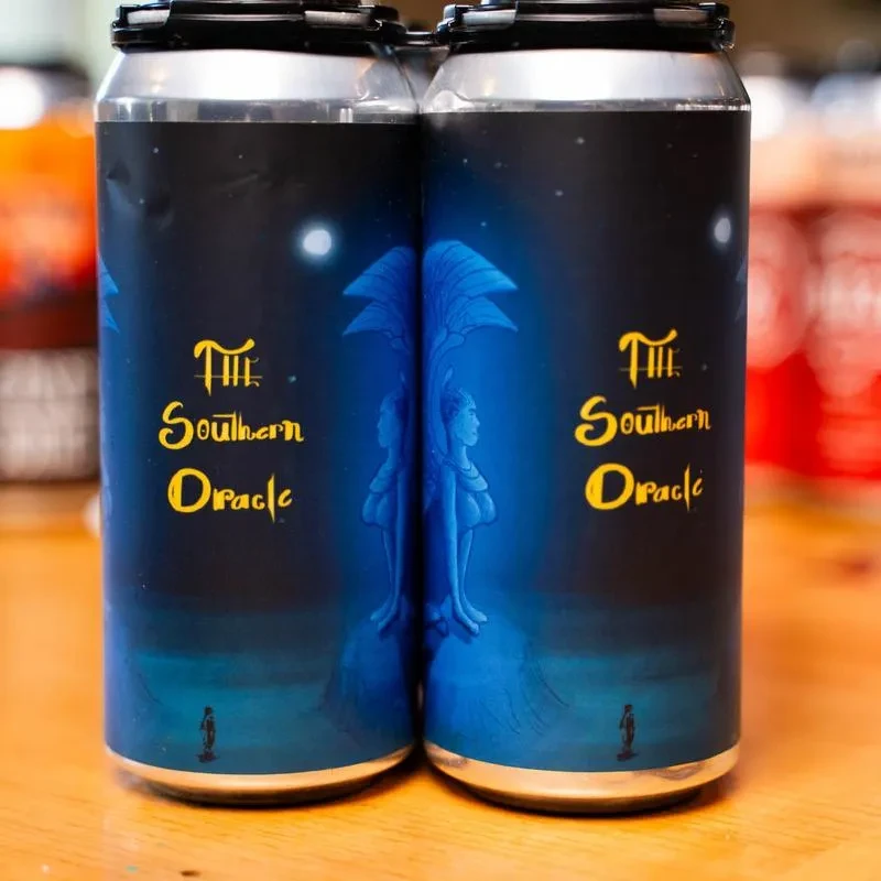 Two cans with "The Southern Oracle" label and winged figure art.