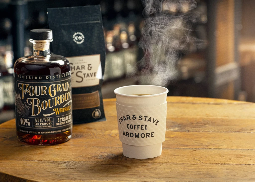 Bluebird bourbon bottle, steaming Char & Stave coffee cup and bag.