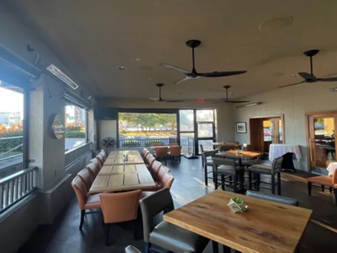 Modern restaurant with indoor dining and an enclosed, heated patio.