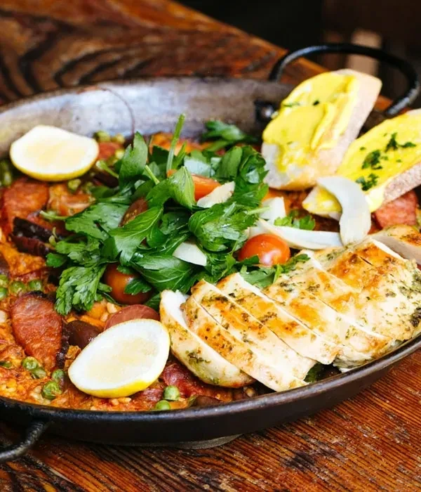 Paella-style chicken and chorizo rice with lemon and bread.