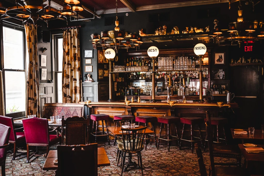 Richly decorated bar interior with dog decor and 'BEST FRIEND' lights.