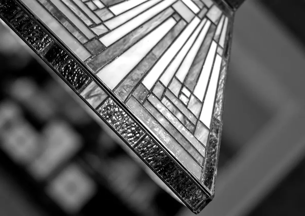 Close-up black and white geometric light fixture with textured glass.