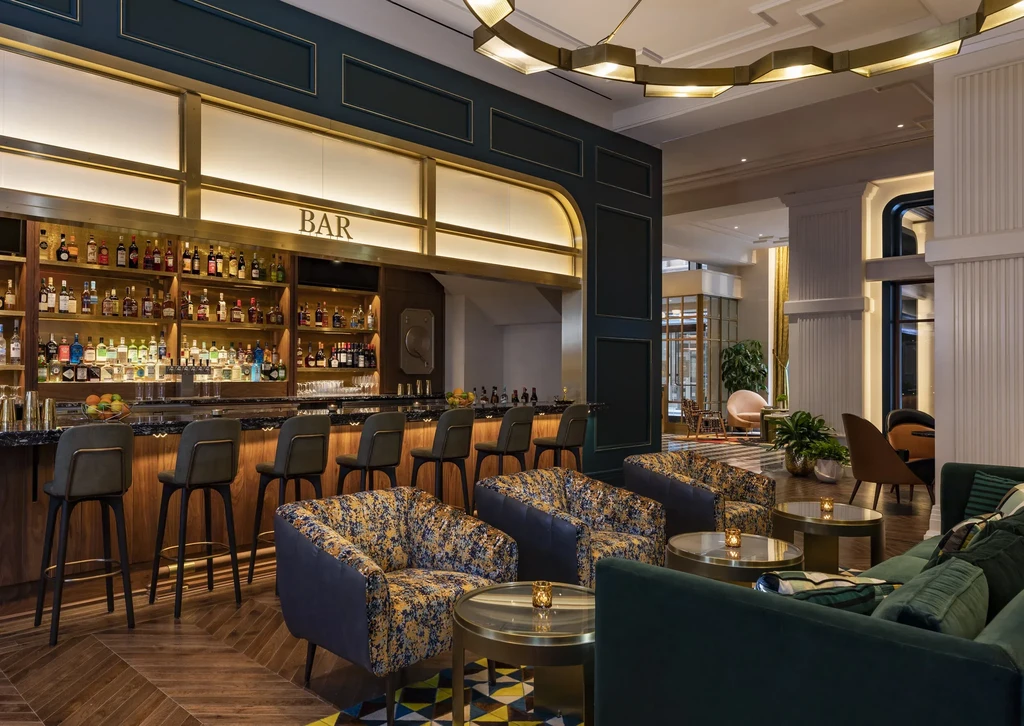 Well-appointed, empty bar and lounge with stocked shelves and seating.