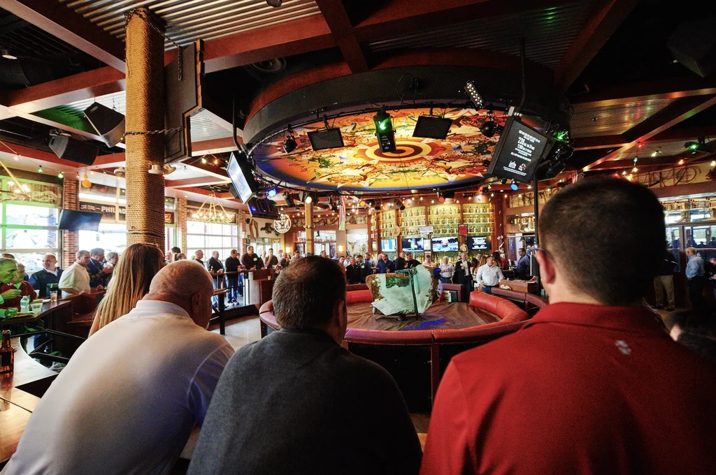 Restaurant interior with unique ceiling art and covered central feature.