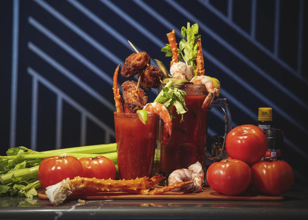 Two Bloody Marys with chicken, crab, shrimp, celery, and tomatoes.