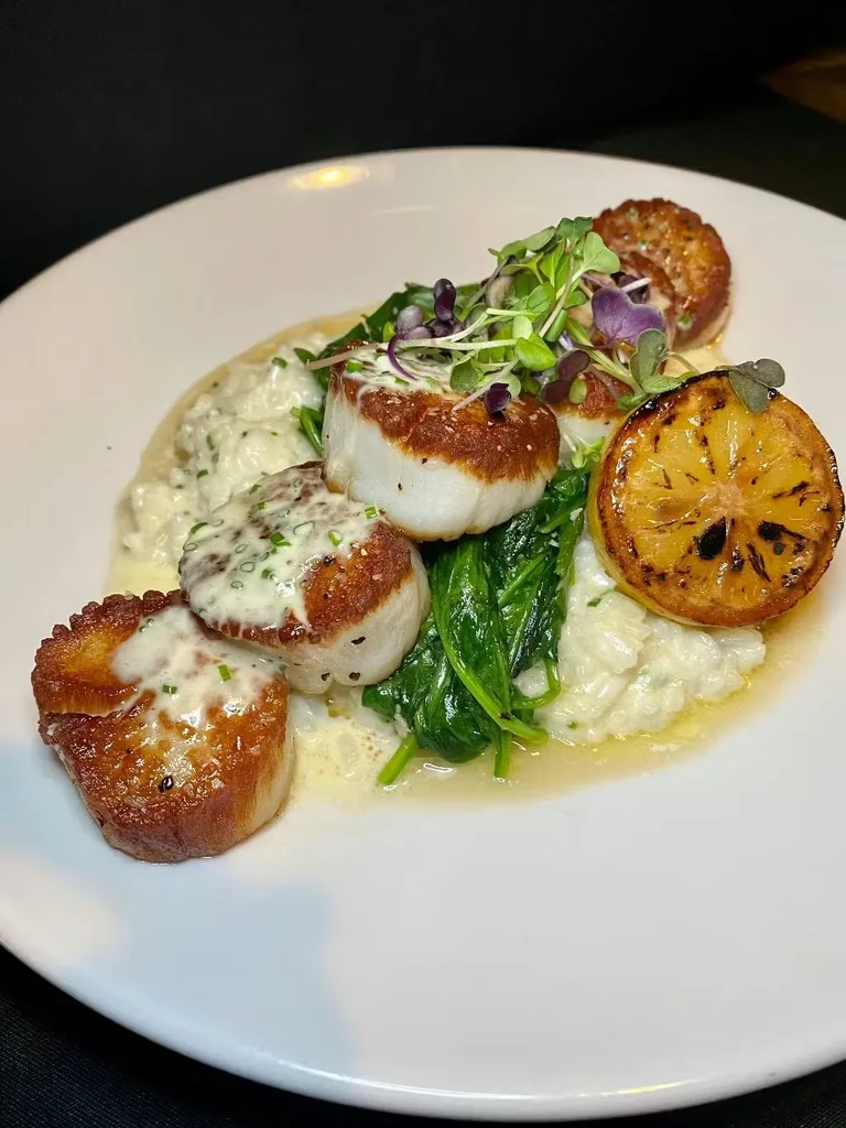 Five pan-seared scallops, creamy risotto, spinach, grilled lemon, microgreens.