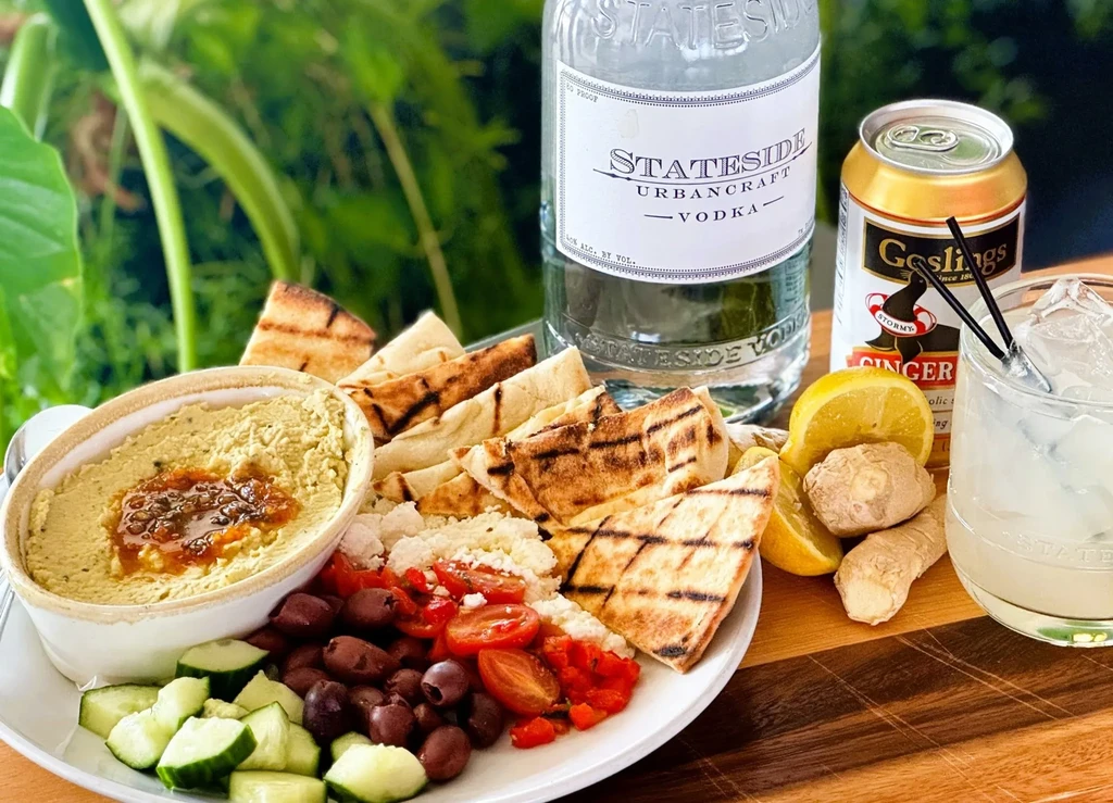 Hummus platter, pita, vegetables, and Stateside vodka ginger beer.