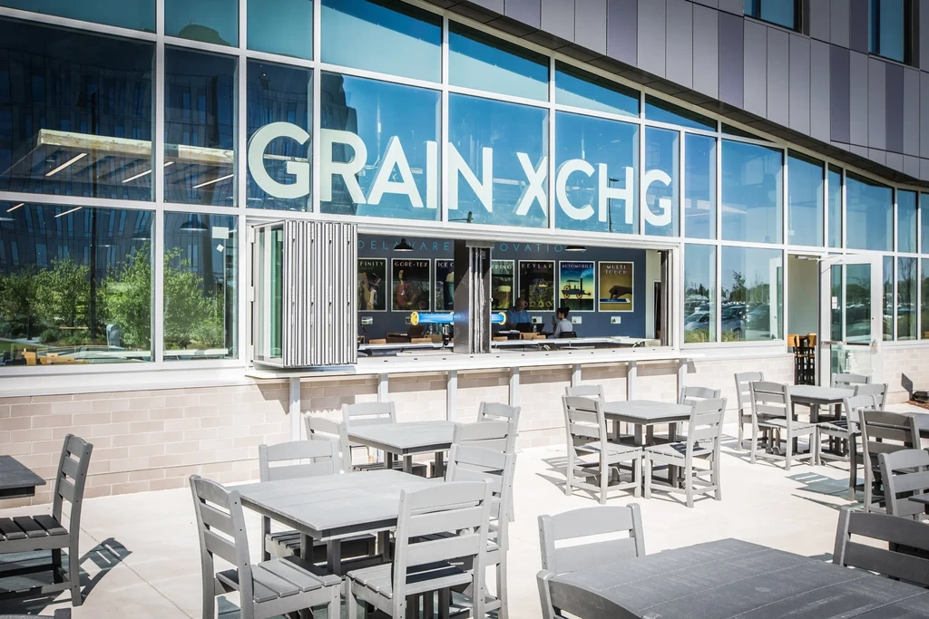GRAIN XCHG outdoor patio with tables and an open walk-up bar.