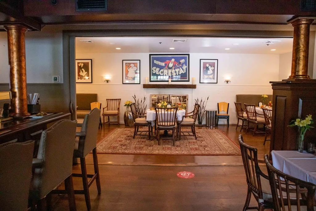 Classic restaurant interior featuring a bar and elegant dining room.