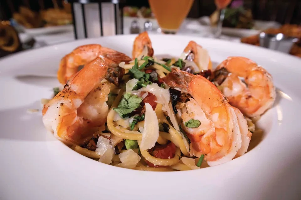 Shrimp pasta dish with tomatoes, herbs, and Parmesan cheese.