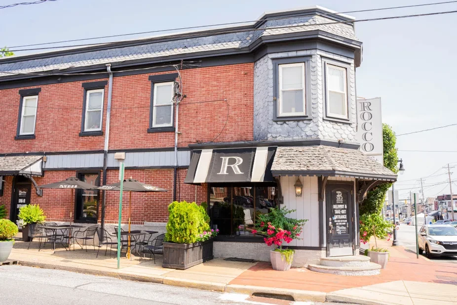 Rocco restaurant's corner building with bay window and outdoor dining.