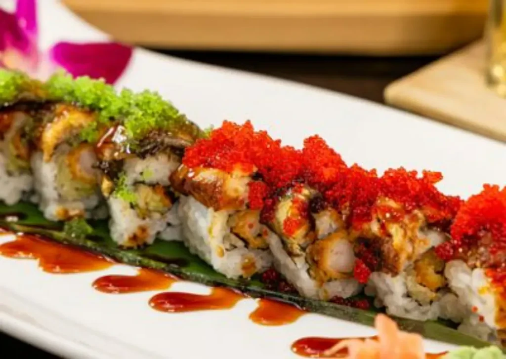 Elaborate sushi rolls topped with eel, shrimp tempura, red and green roe.