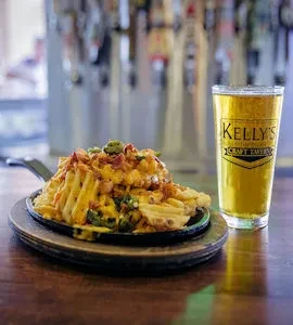Loaded waffle fries with cheese, bacon, and beer at a bar.