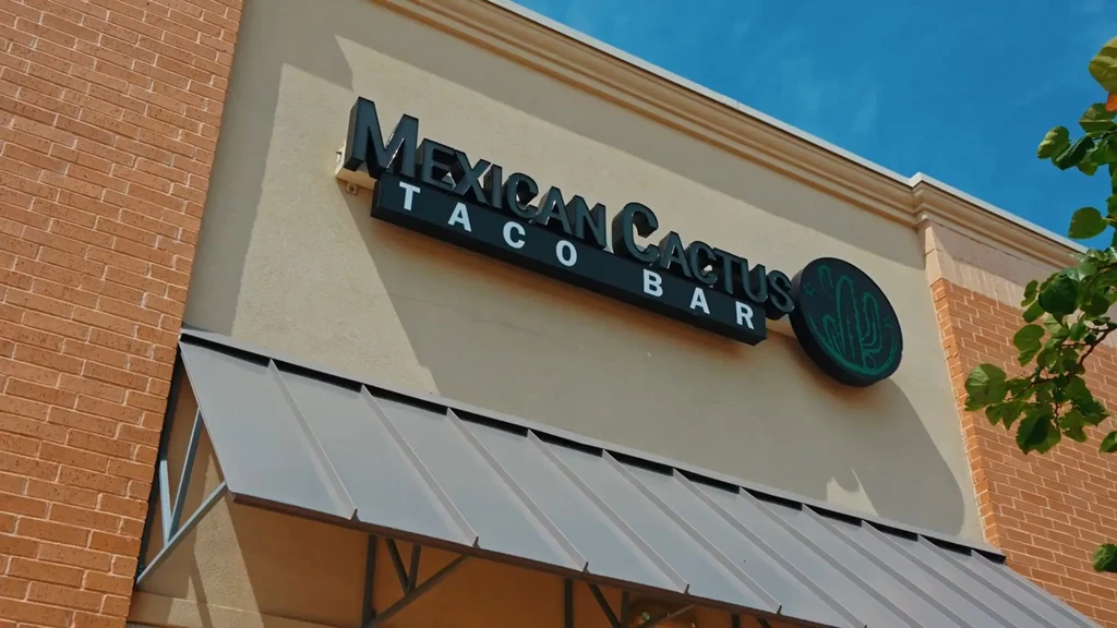 Sign for Mexican Cactus Taco Bar with a green cactus logo.