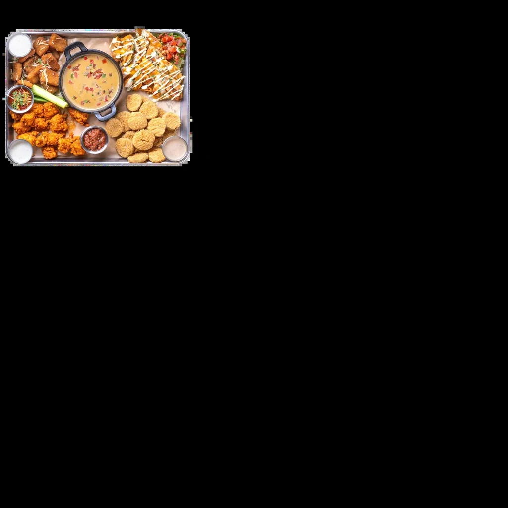 Large tray filled with nachos, wings, fried appetizers, and creamy cheese dip.