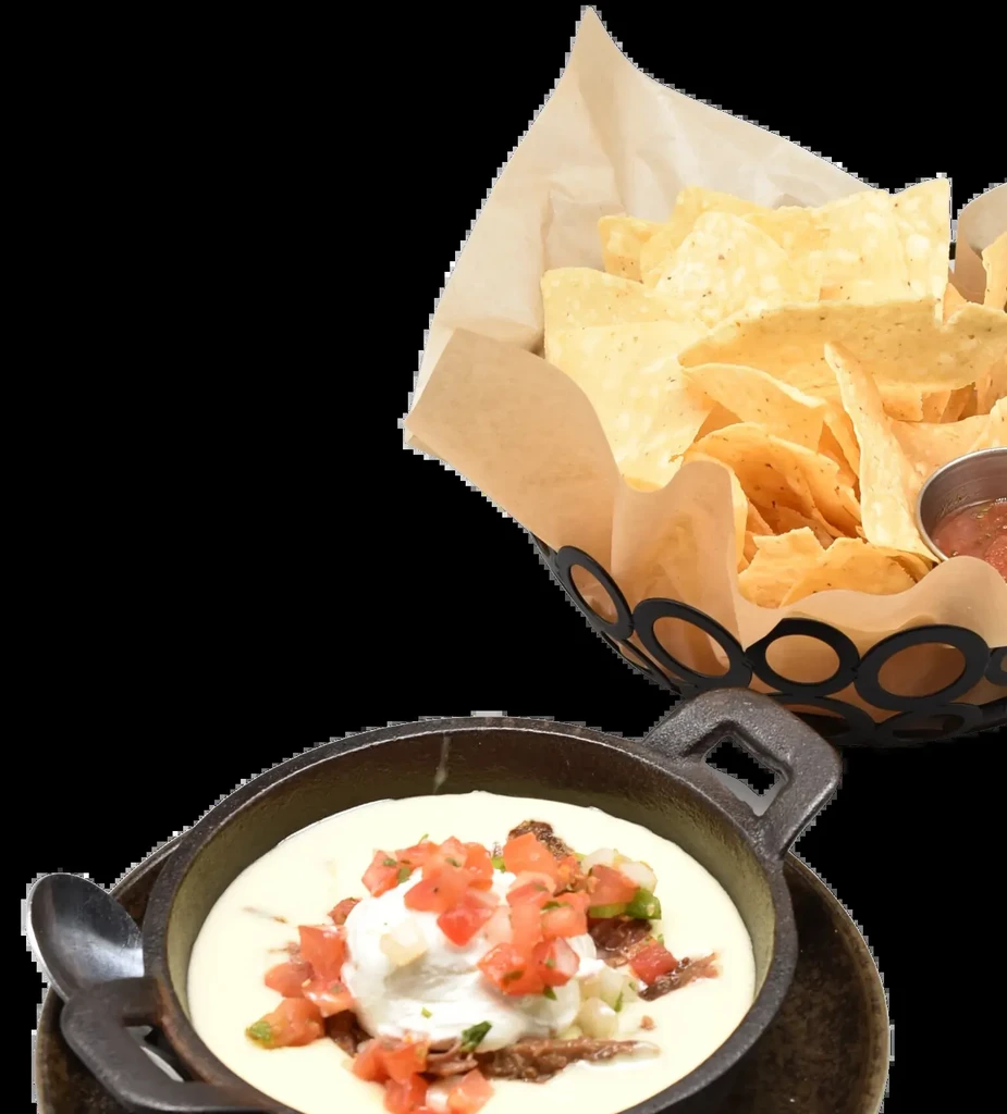 Skillet of cheese dip with pico de gallo, chips, and salsa.