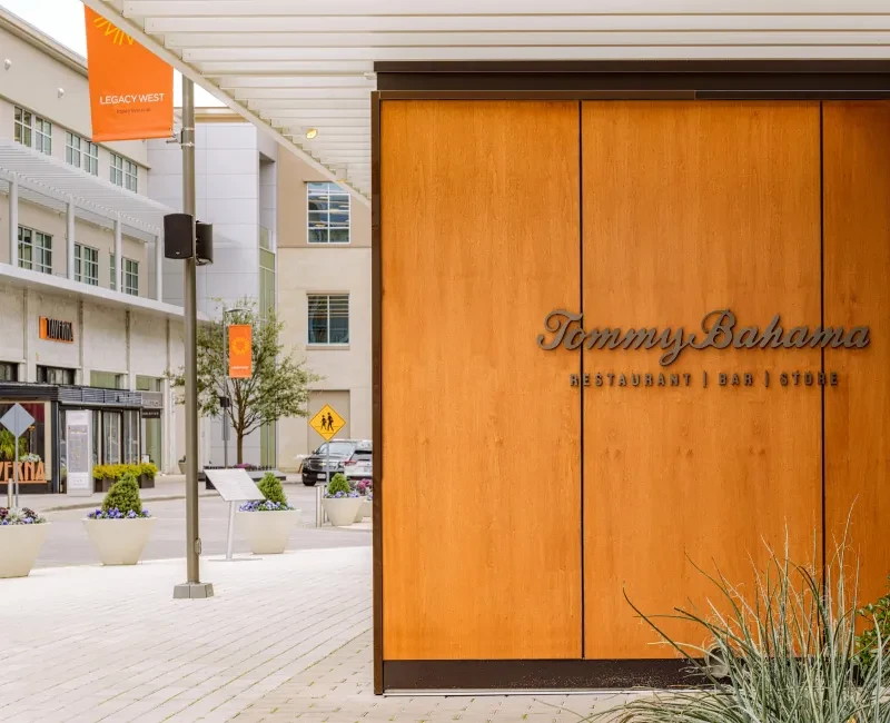 Wooden Tommy Bahama restaurant, bar, store facade on a modern street.