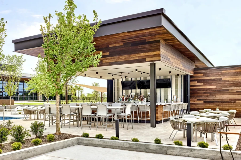 Modern upscale outdoor bar, dining, and pool area. No people.