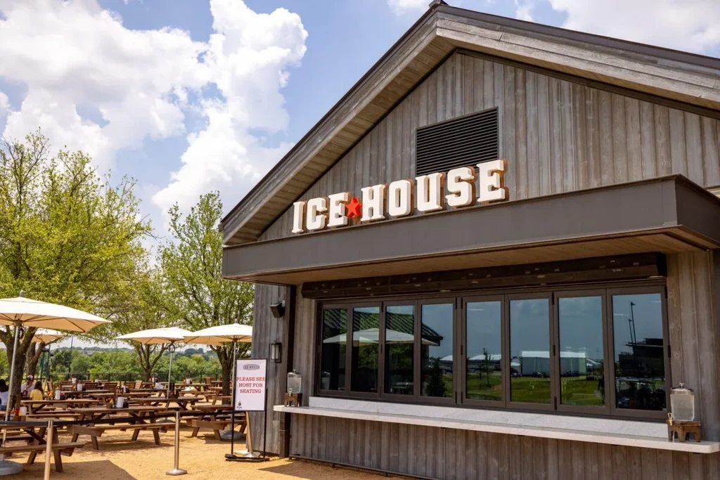 Ice House restaurant with outdoor patio, picnic tables, and umbrellas.