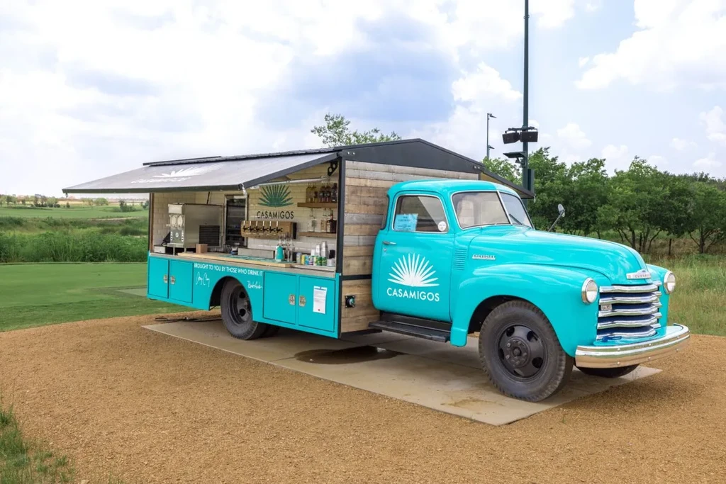 Teal vintage Chevy truck converted into a Casamigos mobile bar.